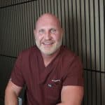 Dr. Kaleb Falk, naturopathic doctor in Kamloops, BC, seated in clinic setting.