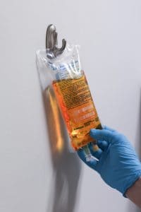 iv-drip-therapy-kamloops - Dr. Kaleb Falk Intravenous saline solution prepared for IV therapy in a clinical setting